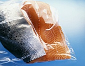 Two salmon fillets with skin in a plastic bag