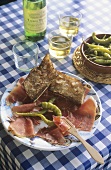 Ham platter with garlic baguette and chillies