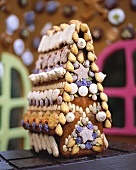Gingerbread house decorated with biscuits, nuts and sweets