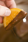 Half orange slice dipped in chocolate