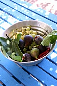 Grapes and figs in a metal bowl