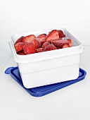 Frozen strawberries in a plastic box
