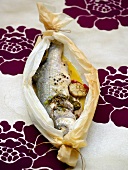 Steamed sea bass in greaseproof paper
