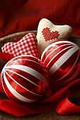 Christmas baubles and fabric hearts in a wooden bowl