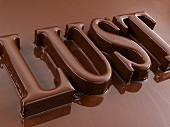 The word 'Lust' coated in chocolate