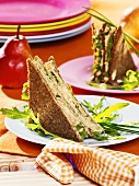 Rocket and soft cheese sandwiches in pumpernickel bread
