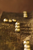 Gold-coated chocolate balls on a piece of tree bark