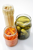Carrots, asparagus and gherkins in jars