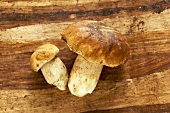 Two ceps on wooden background