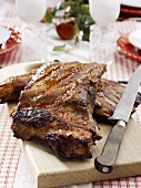 Spare-ribs on a wooden board with knife