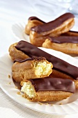 Chocolate eclairs on two plates
