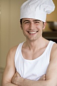 Young man in vest and chef's hat
