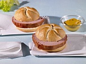 Two bread rolls filled with slices of Leberkäse