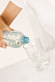 Pouring a glass of mineral water