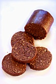 Chocolate rounds cut from roll of chocolate biscuit dough
