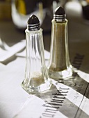 Salt and pepper shakers on a newspaper