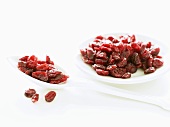 Dried cranberries on spoon and plate