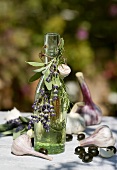 A bottle of olive oil with sprig of lavender