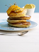 Pancakes with orange slices and maple syrup