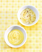 Mayonnaise and mustard mayonnaise in small dishes