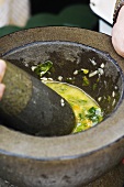 Basil and chilli dressing in mortar