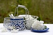 Tableware in basket, white hydrangeas