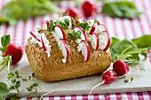 Sesame roll filled with quark, radishes and cress