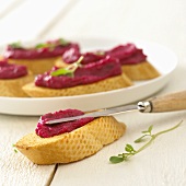 Beetroot spread on toasted baguette slices
