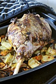 Leg of lamb studded with rosemary & garlic in roasting tin