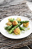 Breaded cheese cubes with green asparagus