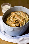 Onion soup with cheese croutes in pot