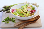 Potato salad with raw green asparagus and radishes