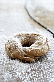 A bagel on a wooden surface