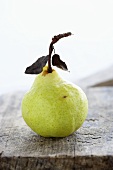 A pear on a wooden board