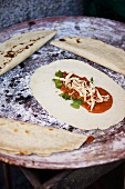 Tortilla with chicken and tomato sauce