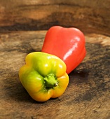 Two peppers on wooden surface