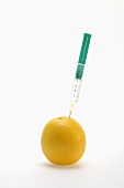 An orange and a syringe