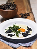 Fried egg with black chanterelle mushrooms