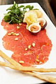 Beef carpaccio with pine nuts and figs