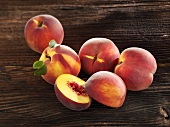 Yellow-flesh peaches on a wooden surface