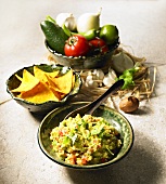 Guacamole with tortilla chips and ingredients