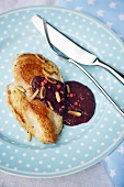 Chicken breast with blackberry sauce and pine nuts
