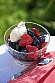 A berry salad with balsamic vinegar and cream