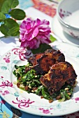 Crispy chicken with char and raisins on a garden table