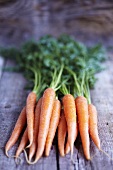 Fresh carrots on wooden background