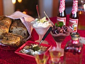 A buffet with various herring salads and fruit bread