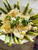 Green asparagus with a fried egg and basil