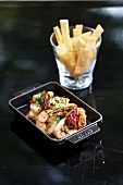 Fried prawns with herbs and dried chilli peppers and toasted bread sticks