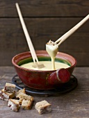 Swiss cheese fondue with cubes of wheat and rye bread