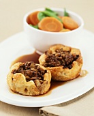 Two puff pastry shells filled with minced beef